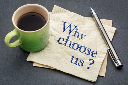 67601329 - why choose us? handwriting on a napkin with cup of coffee against gray slate stone background